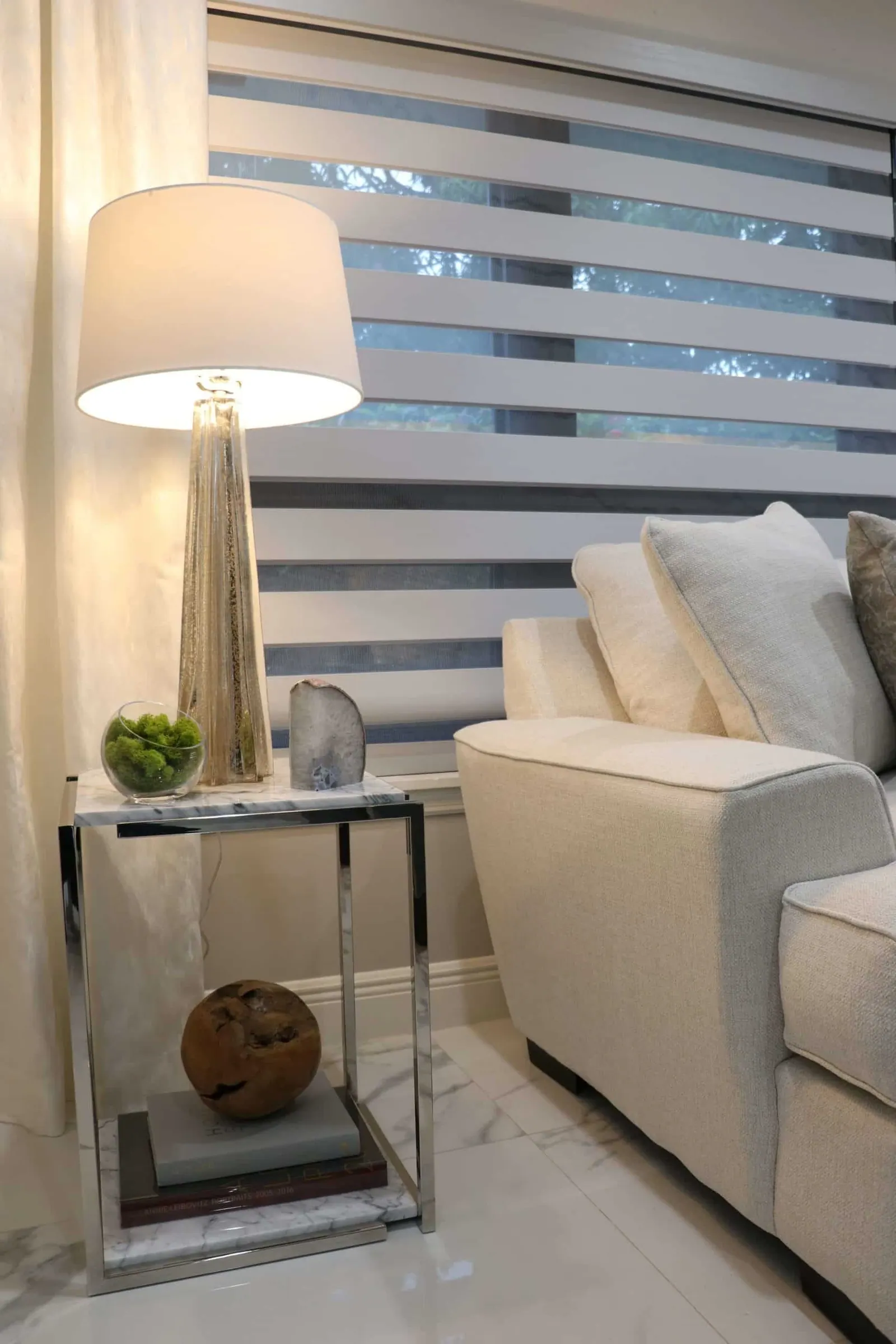 Soft lighting and elegant accesories next to a white couch