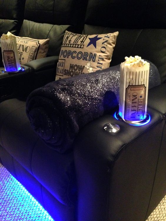 Pop corn and candies on sofa at self owned cinema room