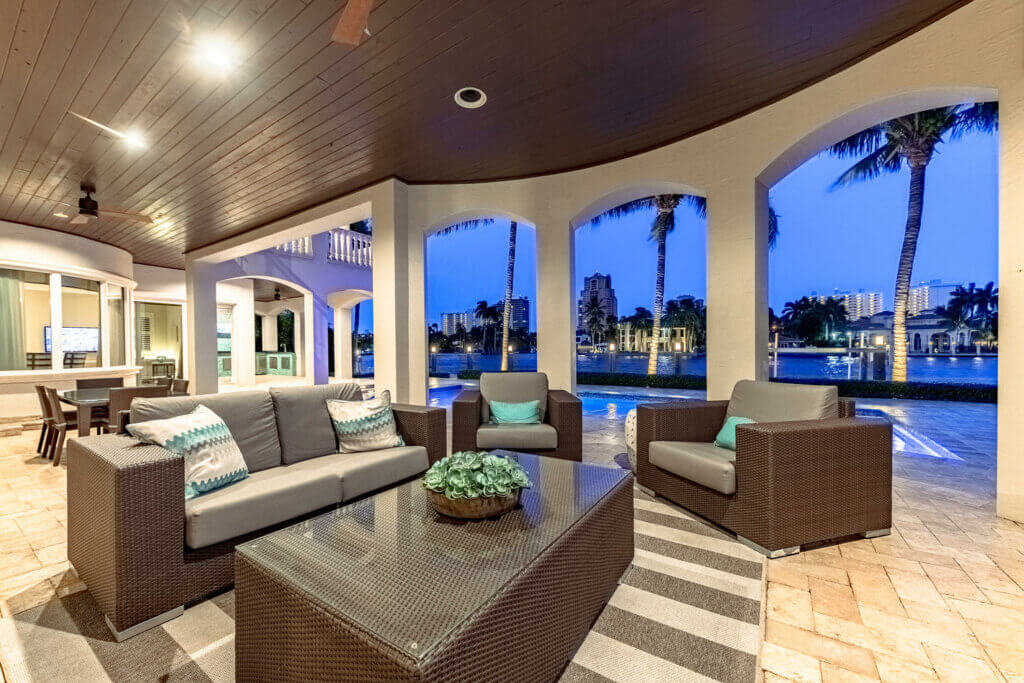 Classy outdoor area by the pool in coastal home
